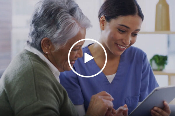 a nurse with an older woman looking at a screen